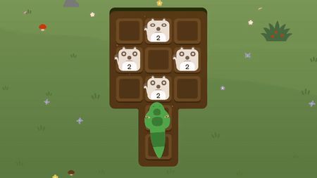 Snake entering a small dirt grid with four number-2 animal tiles in a grassy meadow